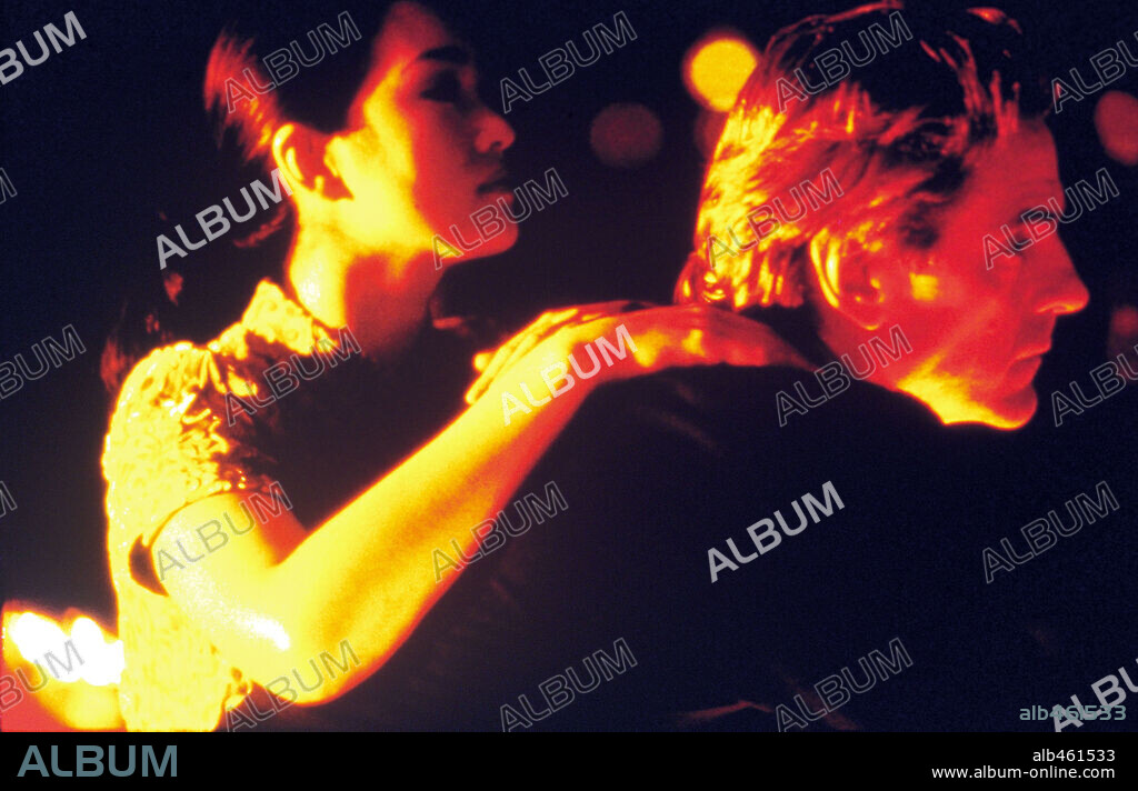JEREMY IRONS and LI GONG in CHINESE BOX, 1997, directed by WAYNE WANG. Copyright TRIMARK PICTURES.