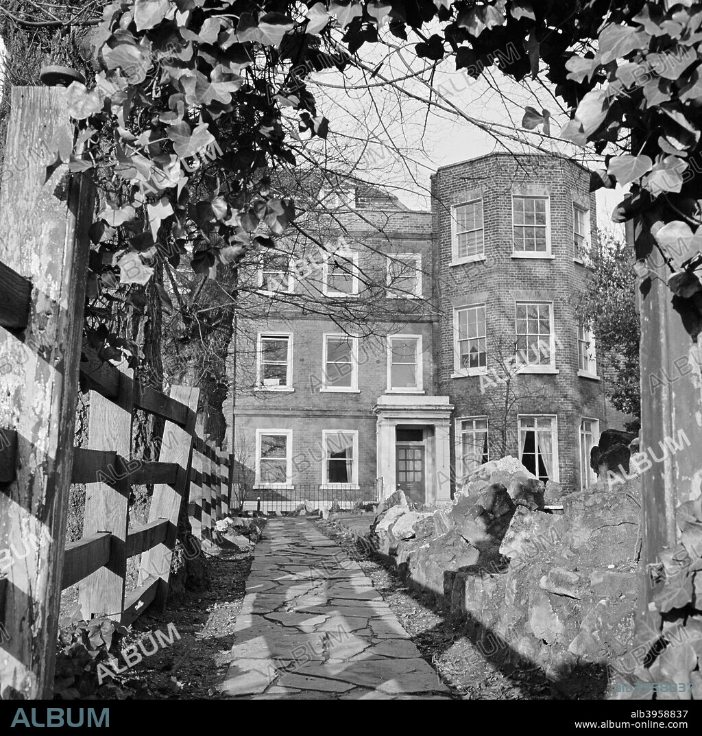 Windmill Hill House, Windmill Hill, Hampstead, London, 1960-1965. The front elevation of Windmill Hill House, viewed from the garden path with an arch of ivy overhead.