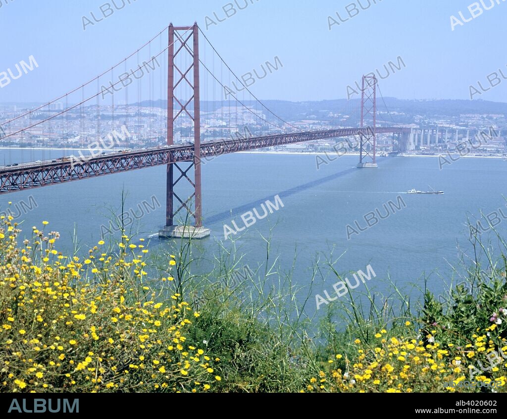 25th April Bridge over the River Tagus, Lisbon, Portugal. The Ponte 25 Abril is the largest suspension bridge in Europe, and is 2.3 kilometre long. It was completed in 1966. Originally called the Salazar Bridge, it was renamed to commemorate the day of the 1974 Portuguese Revolution.