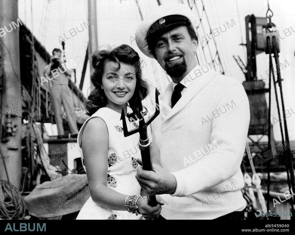 Shark Hunting By Camera -- Han Hass with his wife Lotte.Hunting sharks with a camera holds few terrors for Dr. Hans Hass, the underwater explorer - or his 24 year old Viennese wife, Lotte. He just shakes his fist at them. Tomorrow (Friday) they sail from the Thames in their 350 ton schooner Xafira, on a seven months trip to the Caribbbean. August 27, 1953.