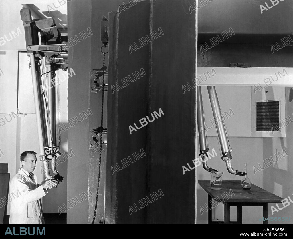 Chicago, Illinois, 1956 Dr. Leonard Reiffel, manager of research at the Armour Research Foundation of the Illinois Institute of Technology, running the slave manipulator behind three foot thick windows in the hot cell of the new nuclear reactor.