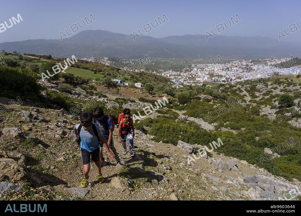 hikers ascending towards Jebel Tizouka, Chefchaouen, Talassemtane National Park, Spanish Mosque, Chauen, morocco, africa.