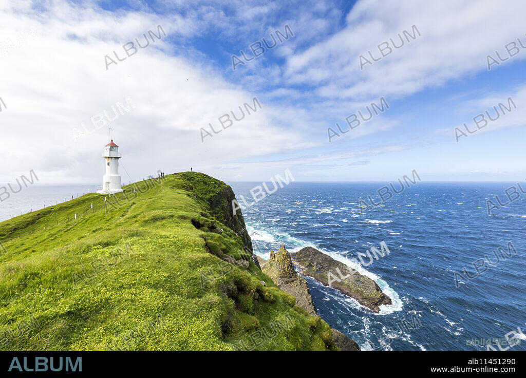 Lighthouse on islet known as Mykines Holmur, Mykines Island, Faroe Islands, Denmark, Europe.