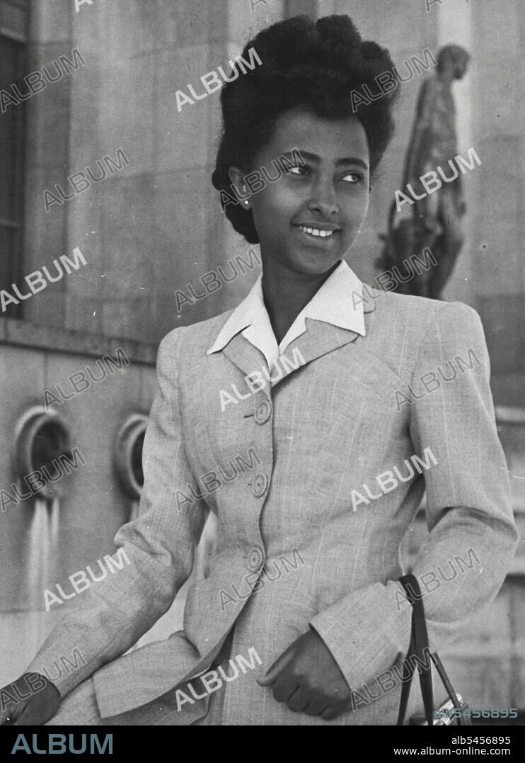 Paris Conference Beauties -- Elizabeth Teguen, 20 years old, ht. 5 feet, wt. 102 lbs, bust 32, hips 32, waist 24, has black hair and eyes. Telephone number is Addis Ababa 9458. Father is Ambassador to France and she is a student at the Sorbonne, but now helping as a secretary to the Ethiopian delegation. Grey suit made in Paris. Ambitious, shyly admitted, are just marriage. Lived in hiding throughout Italian occupation of her country. Can only be described as "cute". August 01, 1950. (Photo by Pictorial Press).
