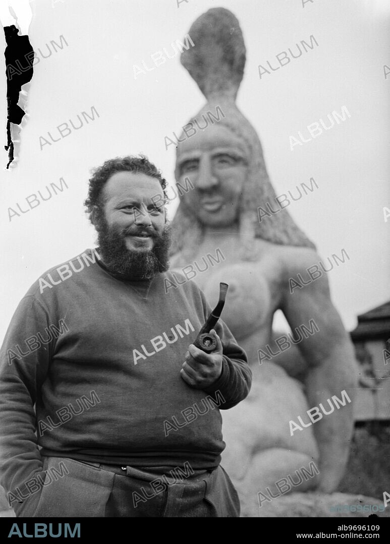 Creates ' Biggest Ever ' statue in his garden. Jack Bilbo , who once described his adventures in America's underworld in a book called ' I Carried a Gun for Al Capone ' and is now a busy artist and owner of a London art gallery , has completed with the aid of two friends , Sid and Bink Harris , what is believed to be the largest piece of sculpture ever created . The statue, representing a kneeling woman , is one solid piece of stone weighing 44,000 pounds. It is 16 feet high . The work done in secrecy at Mr Bilbo's home, 'Bilbo Bay' , Weybridge , Surrey , and now stands in his garden. In their spare time , Mr Bilbo and his friends have built a Museum of Modern Art in the grounds of the house. ' Devotion ' and another large sculpture , ' Life ' , together with Bilbo paintings will be shown there when it is opened on 6 Ocotber as a non-profit making permanent art exhibiton. "Devotion' and 'Life' - which is 7 feet 5 ins high and represents a strong, virile woman rising from the ruins of war - will afterwards tour to New York, Chicago and San Francisco and will be shown at the London World Fair in 1951. Photo shows: Jack Bilbo with his giant statue ' Devotion ' in the garden of his home at Weybridge , Surrey. 25 September 1946.