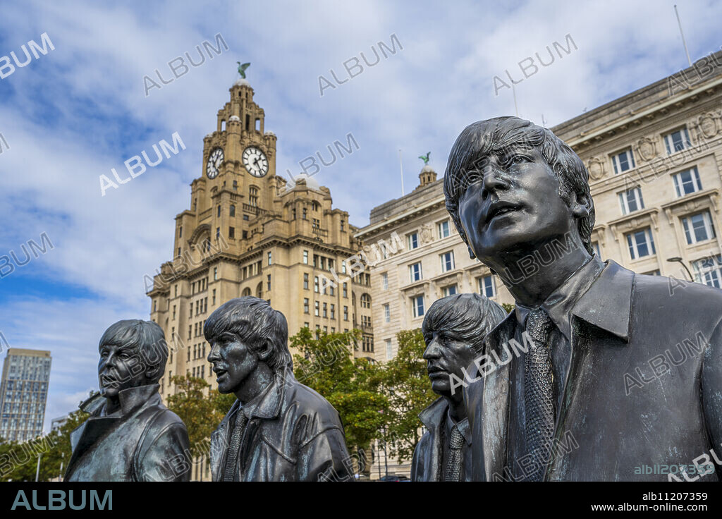 The bronze statue of The Beatles on the Liverpool Waterfront with Liver Building, Liverpool, Merseyside, England, United Kingdom, Europe.