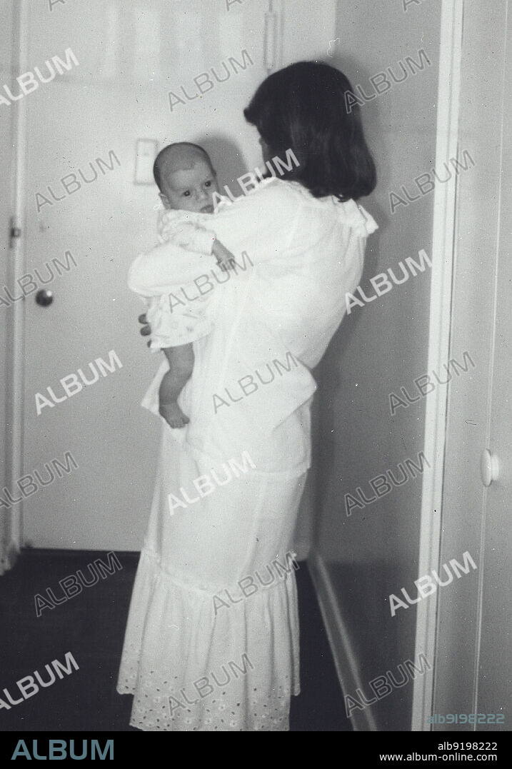 LISA, MARIE PRESLEY], [PRISCILLA, PRESLEY, LISA MARIE PRESLEY and PRISCILLA PRESLEY. Circa 1968, Memphis, Tennessee, USA: Actress and wife of Elvis, PRISCILLA PRESLEY dressed in white holding her new baby daughter LISA MARIE PRESLEY. (Credit Image: © Globe Photos/ZUMA Wire).