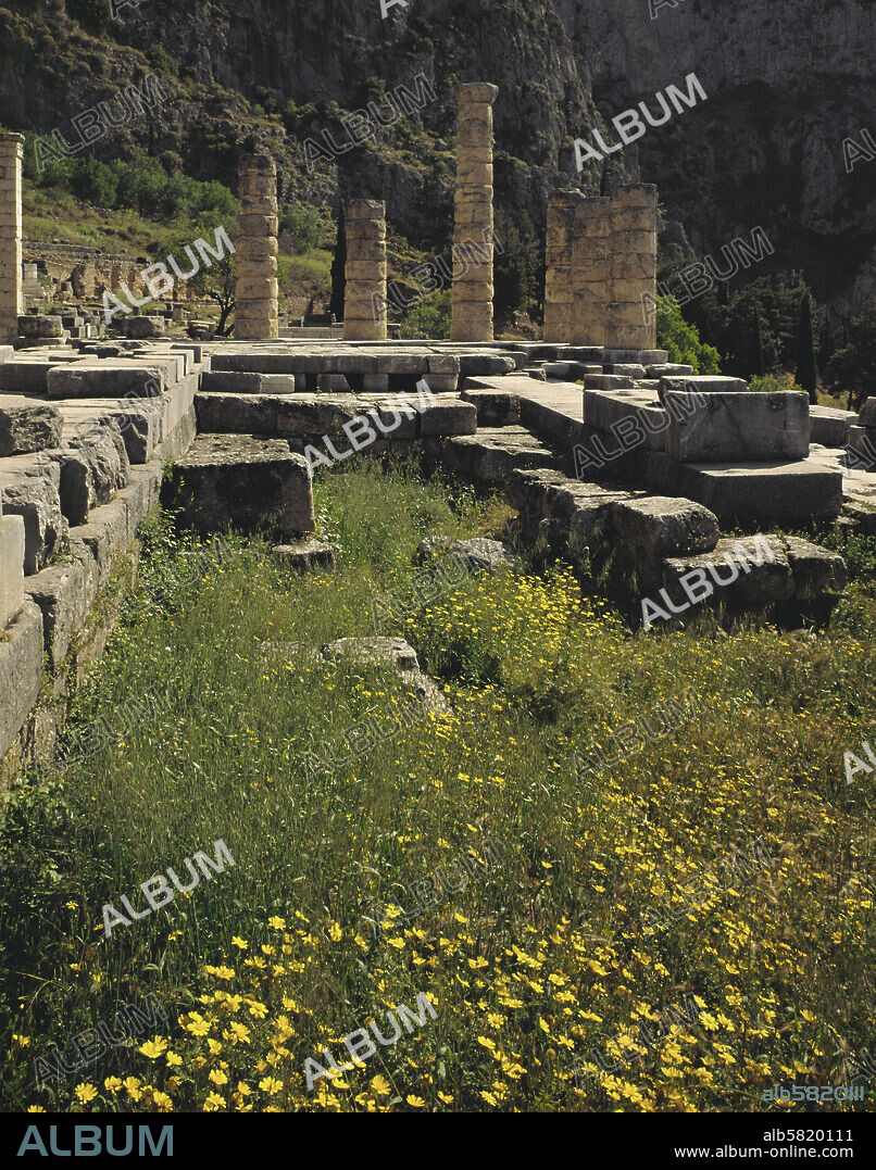 Temple of Apollo, Delphi, seen from Pythia's cave, erected on the site of older sanctuaries, of which the last, from the 6th BCE, was destroyed by an earthquake in 373 BCE. The present building dates from 329 BCE. The Pythia prophesied here. 24.6 x 60 m.