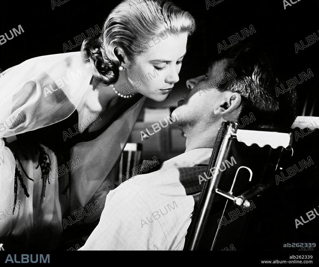 GRACE KELLY and JAMES STEWART in REAR WINDOW, 1954, directed by ALFRED HITCHCOCK. Copyright PARAMOUNT PICTURES.
