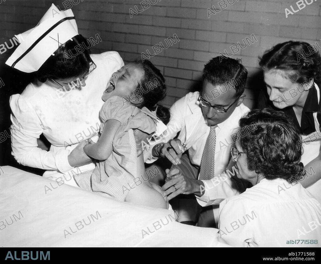 Jonas Salk inoculating polio vaccine. American physician Jonas Salk, developer of the polio vaccine, inoculating the vaccine to a girl. USA, 1950s.