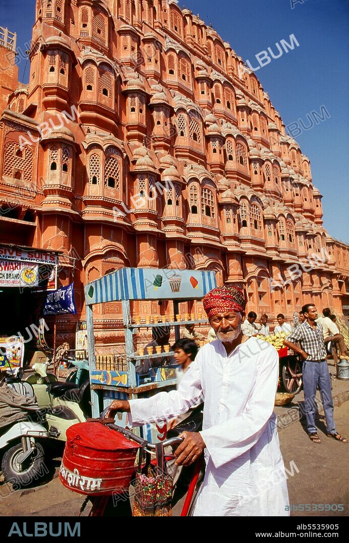 The Hawa Mahal was built in 1799 by Maharaja Sawai Pratap Singh, and designed by Lal Chand Ustad in the form of the crown of Krishna, the Hindu god. Jaipur is the capital and largest city of the Indian state of Rajasthan. It was founded on 18 November 1727 by Maharaja Sawai Jai Singh II, the ruler of Amber, after whom the city was named. The city today has a population of 3.1 million. Jaipur is known as the Pink City of India. The city is remarkable among pre-modern Indian cities for the width and regularity of its streets which are laid out into six sectors separated by broad streets 34 m (111 ft) wide. The urban quarters are further divided by networks of gridded streets. Five quarters wrap around the east, south, and west sides of a central palace quarter, with a sixth quarter immediately to the east. The Palace quarter encloses the sprawling Hawa Mahal palace complex, formal gardens, and a small lake. Nahargarh Fort, which was the residence of the King Sawai Jai Singh II, crowns the hill in the northwest corner of the old city. The observatory, Jantar Mantar, is a World Heritage Site.