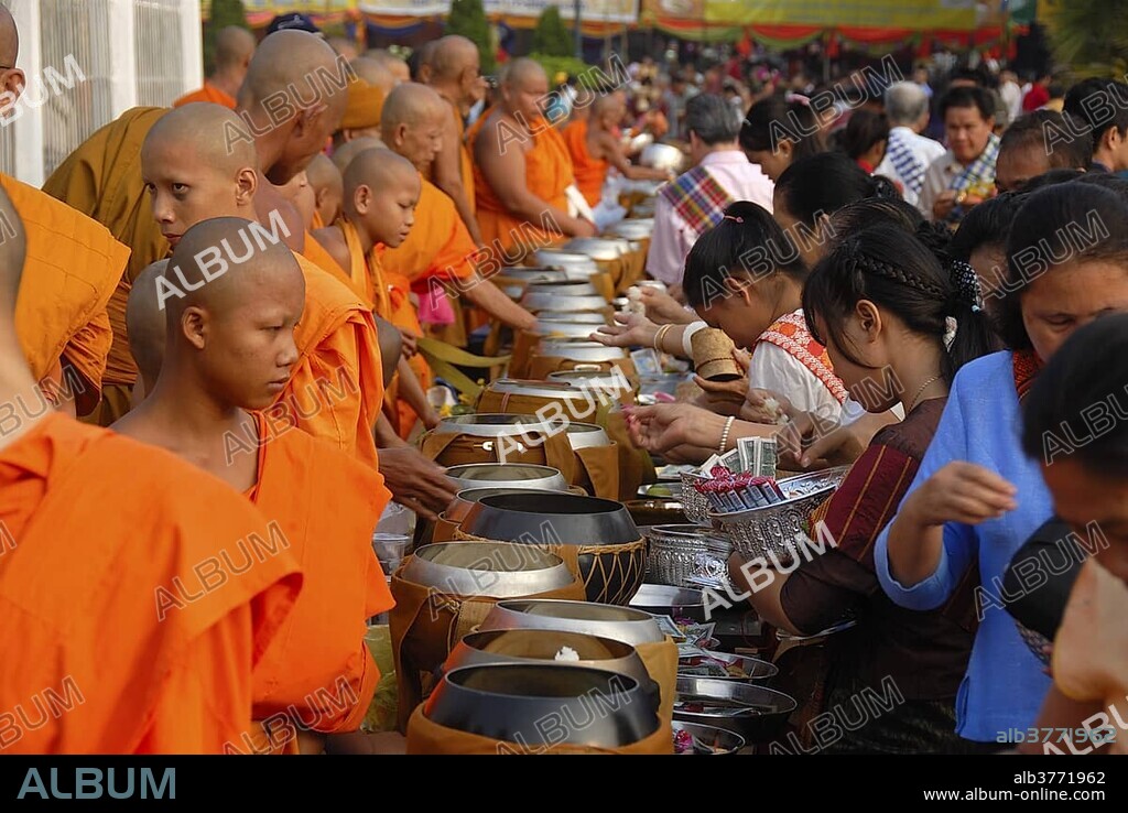 Theravada Buddhism, That Luang Festival, Tak Bat, monks standing behind begging bowls, believers, pilgrims giving alms, orange robes, Vientiane, Laos, Southeast Asia, Asia.
