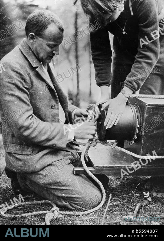 Hege, Walter Fotograf.-Walter Hege bei Dreharbeiten zu dem Film "Am Horst der wilden Adler": Mit Seilen wird die Kamera in 25 m Höhe gebracht.-Foto, um 1935.