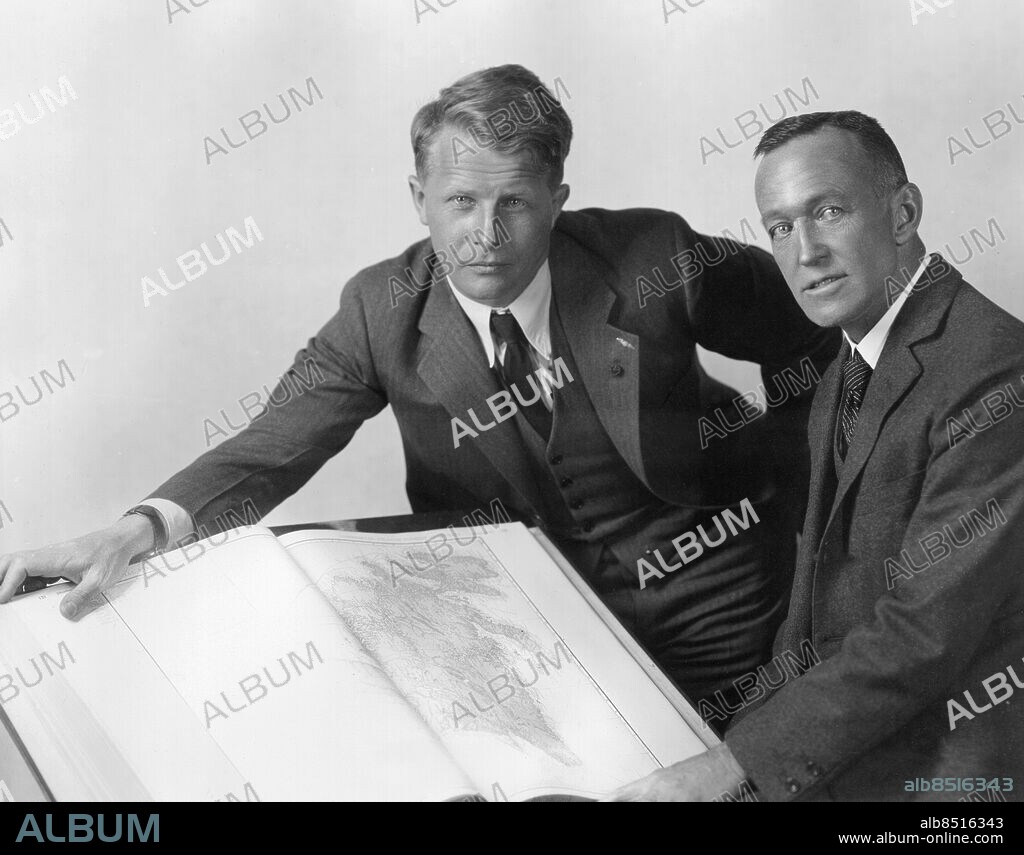 Orig. bildtext... PLANNING TO MAP THE ANTARCTIC WASTES. New York City.-Lincoln Ellsworth (right), veteran of two daring air expeditions to the North Polar regions, and Bernt Balchen (left), the man who piloted Admiral Byrd on his trans-Atlantic and Antarctic flights, are here shown looking over plans for their bisecting of the area known as the Antarctic Continent by airplane. Balchen will pilot the noted explorer. They plan to leave New York early in September, 1933 and go probably by way of the west coast of Australia to a base at Framheim on the Bay of Whales. They hope to make a 2,900 miles flight spanning the continent in what has been termed the last great adventure in South Polar exploration. The flight is expected to supply a wealth of data on this vast unknown area. They expect to return by May, 1934. Anm. L Ellsworth, 1880-1951, amerikansk ingenjör och upptäcktsresande. B Balchen, 1899-1973, norsk-amerikansk polarforskare, pilot. Västar Polarforskare Antarktis Planering CD511 persons: BERNT BALCHEN;LINCOLN ELLSWORTH sites: NEW YORK;USA.