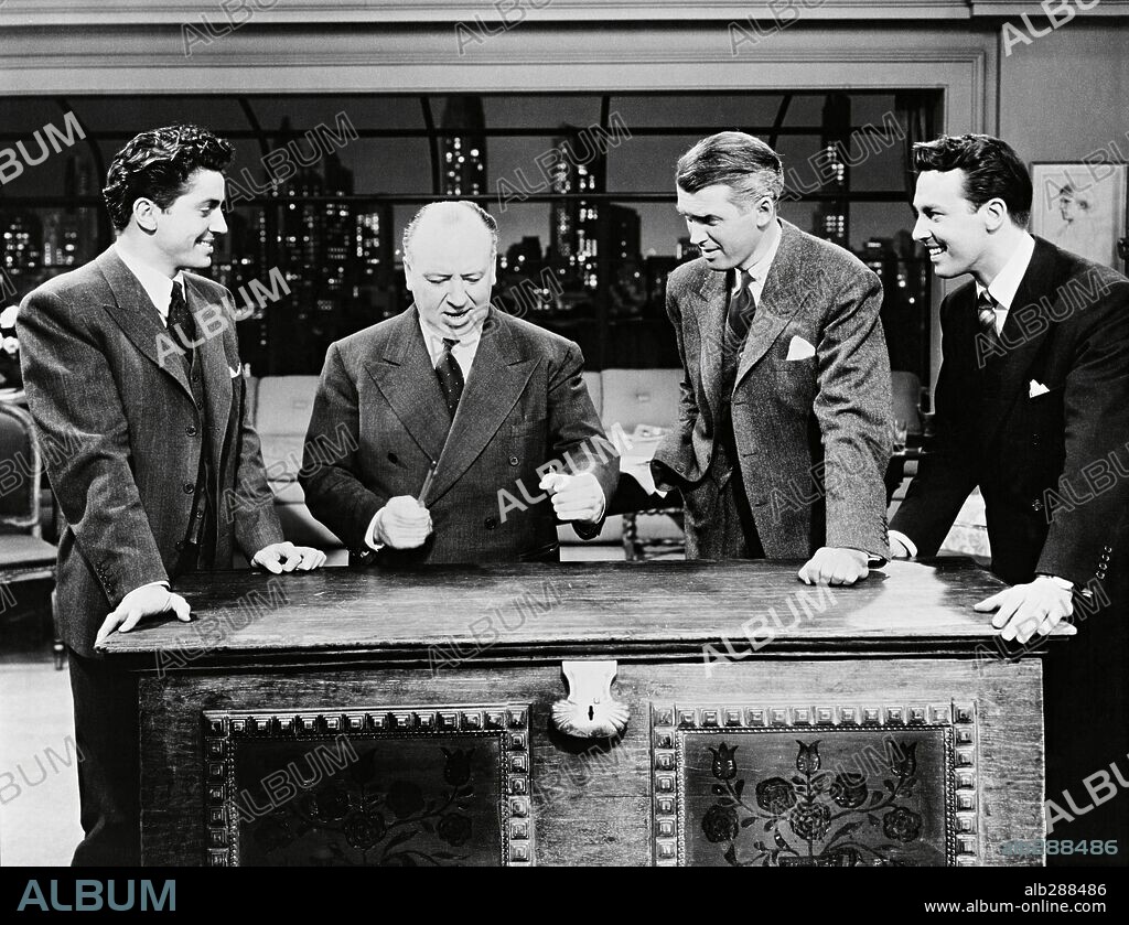 ALFRED HITCHCOCK, FARLEY GRANGER, JAMES STEWART and JOHN DALL in ROPE, 1948, directed by ALFRED HITCHCOCK. Copyright Warner Bros./Transatlantic Pictures.
