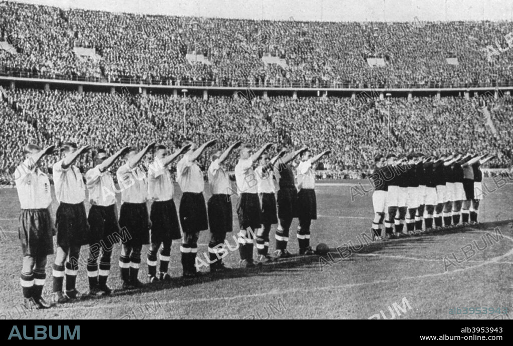 The infamous salute at the Berlin Olympic Stadium, Germany, 1938. Under pressure from British diplomats, the England football team (in the white shirts), captained by Arsenal's Eddie Hapgood, agreed to give the Nazi salute before the match against Germany. Hitler did not attend the match, which England won 6-3. A print from Football Ambassador by EA (Eddie) Hapgood, Sporting Handbooks LTD, London, 1945.