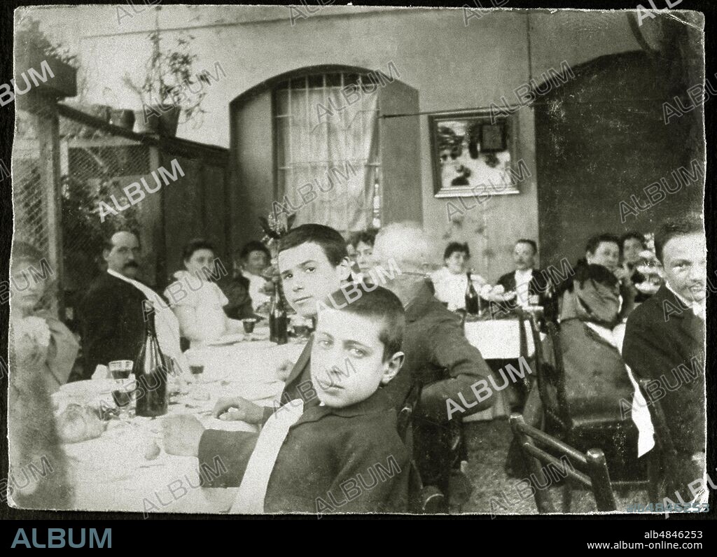 BANQUET outdoor wedding in the trattoria of via Magolfa in Milan; in the foreground two little boys, in the background the bride and groom. Italy, 1897.