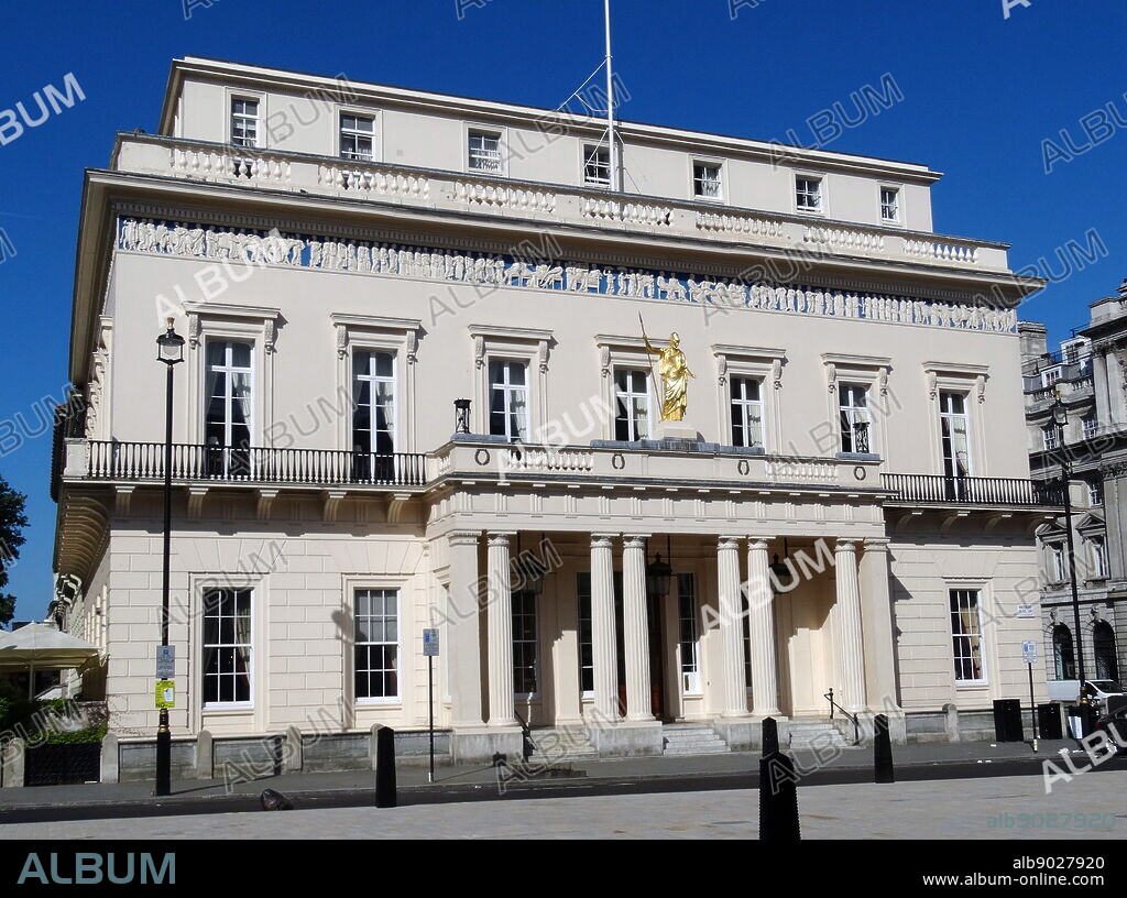 The Athenaeum is a private members' club in London, founded in 1824. It was designed by Decimus Burton in the Neoclassical style with a Doric portico, above which is a statue of the classical goddess of wisdom, Athena. The bas-relief frieze is a copy of the frieze round the Parthenon in Athens.