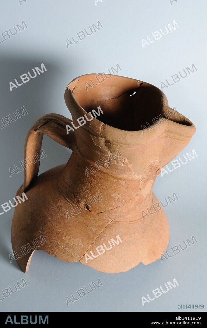 Bisque ceramic jar with a handle and inscription, trilobed mouth. Height 25 cm Diameter mouth 16 cm (13 th ) - Medieval period from the archaeological site of the "Calle Seises " in Alcalá de Henares - "Burgo de Santiuste Museum" (Madrid). SPAIN.