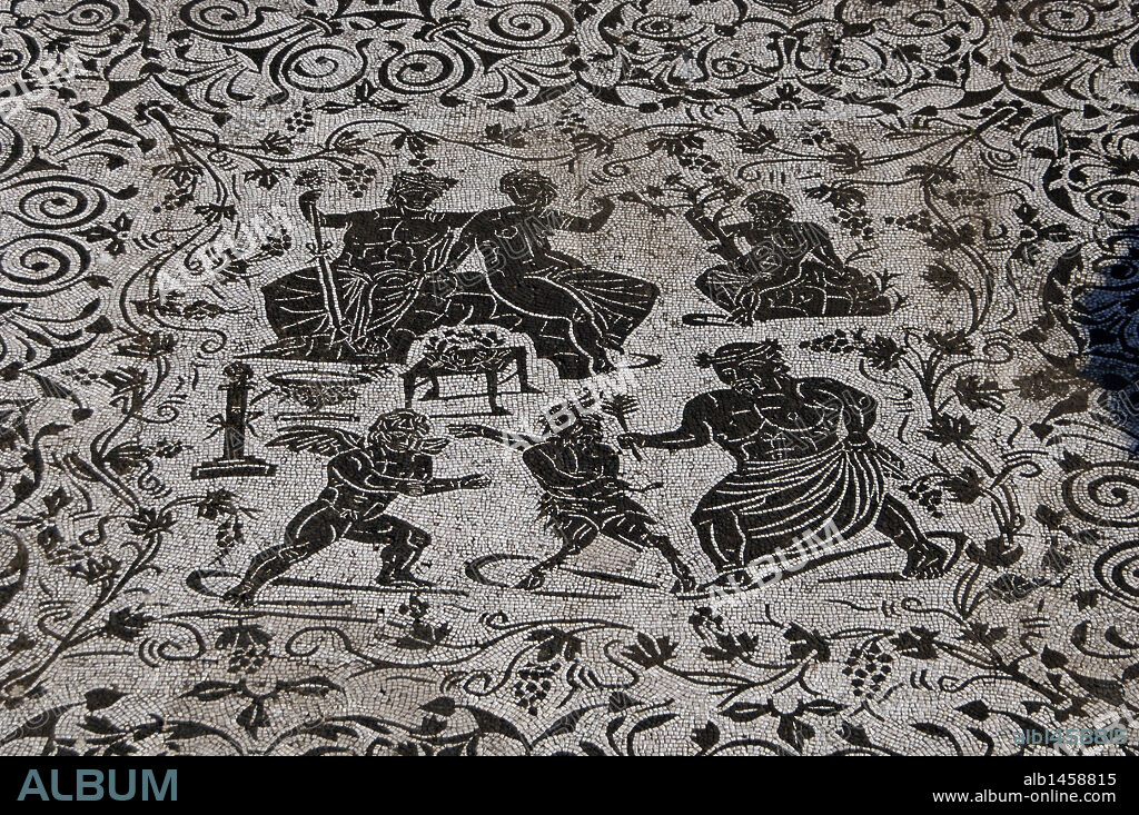 ARTE ROMANO. ITALIA. Detalle de un MOSAICO en blanco y negro decorado con motivos florales. En el panel central, las figuras de BACO (dios del vino) JUNTO A SU MUJER ARIADNA. En la fila inferior, la lucha de EROS Y PAN (el amor y la lujúria). Un viejo sileno media como árbitro. Mosaico perteneciente a la CASA DE BACO, construida en época Adriana. Siglos I-II d. C. Antigua ciudad romana de OSTIA ANTICA. Alrededores Roma. Italia. Europa.