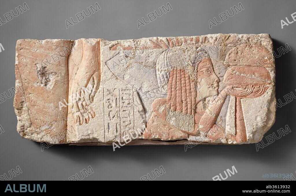 Relief Depicting the Nurse Tia. Dimensions: h. 23.1 cm (9 1/8 in); w. 54 cm (21 1/4 in); th. 3.7 cm (1 7/16 in). Dynasty: Dynasty 18. Reign: reign of Akhenaten. Date: ca. 1353-1336 B.C..
The large figure of the king, at the left, and the smaller figure of a young woman offering bread loaves appear to be participating in two different scenes. The sidelock of hair would usually identify the girl as a princess, but here, the inscription behind her reads "the nurse of the king's daughter Ankhesenpaaten, Tia," and it seems likely that this is a representation of the nurse.
