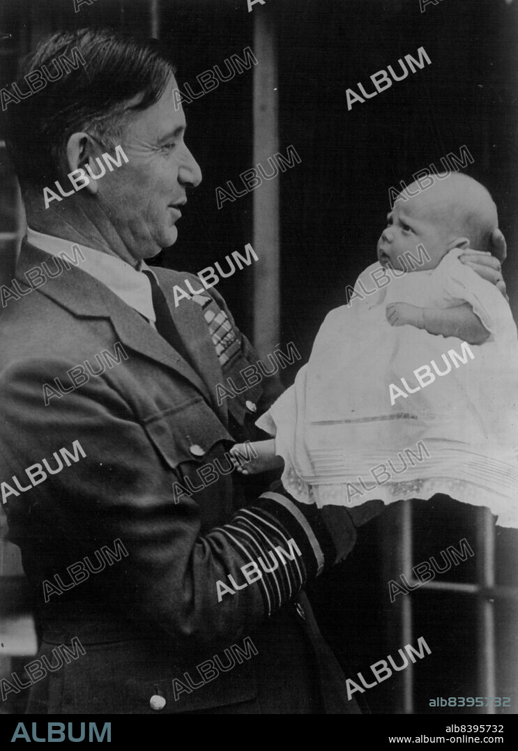 Marshal of the Royal Air Force, Lord Tedder, Chief of the Air Staff, proudly gazes on his baby son, Richard, nick-named "Widget". Richard displays a striking likeness to his celebrated father, but does not seem to appreciate the meeting. August 9, 1946.