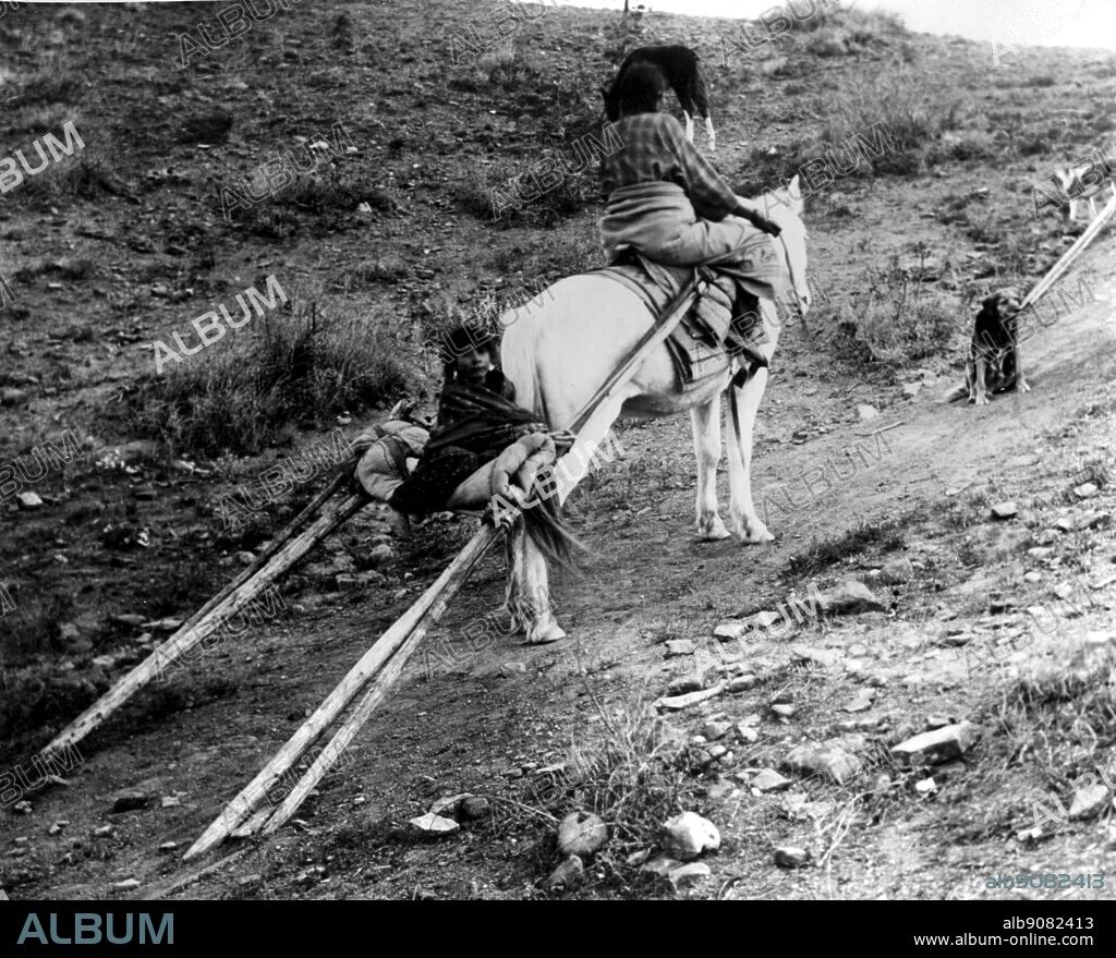 Woman with travois. device used by Native North Americans of the Great Plains for transporting their tepees and household goods. It consisted of two poles, lashed one on either side of a dog or, later, a horse, with one end of each pole dragging on the ground. It had straps or wooden crosspieces between the poles near the open end that served as a carrier. Like the sledge, the travois was used by Native Americans before any use of wheels was known to them.