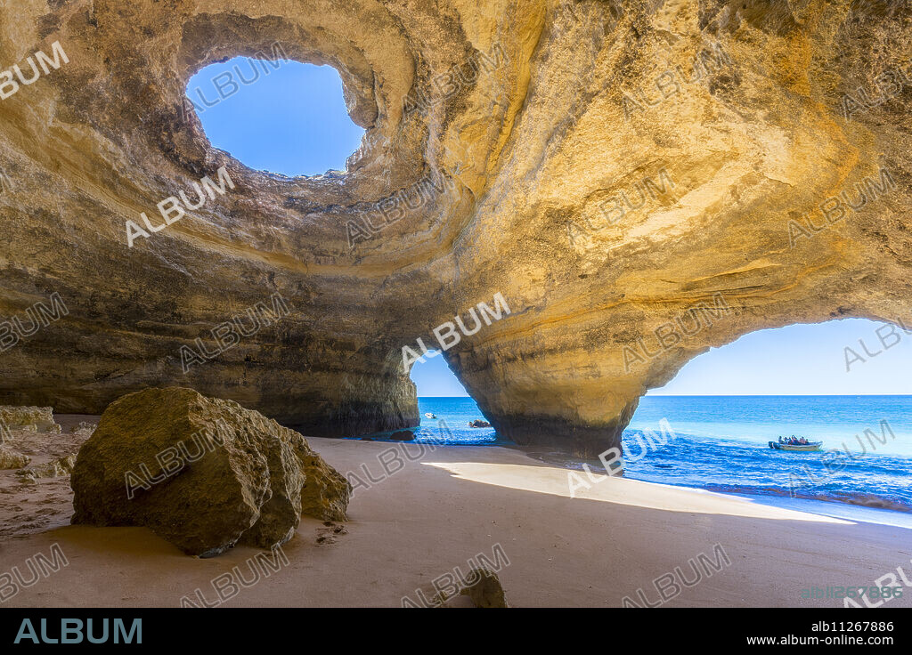 The sea caves of Benagil with natural windows on the clear waters of the Atlantic Ocean, Faro District, Algarve, Portugal, Europe.