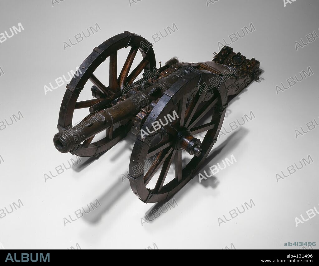 Model Field Cannon (Serpentine). Possibly by Hans Reischperger; Austrian, Vienna, active 1595. Date: 1590-1600. Dimensions: Barrel L. 85.8 cm (33 3/4 in.) 
Caliber: 3.3 cm (1 1/4 in.) 
Carriage L.: 97.2 cm (38 1/8 in.)
Front W.: 13.4 cm (5 1/4 in.)
Trail W. at base: 21 cm (8 1/4 in.)
Diameter of Wheels: 57.5 cm (22 5/8 in.)
Distance between outside of hubs: 52.1 cm (20 1/2 in.)
L. of mounted cannon from muzzle to end of trail: 143.7 cm (53 in.)
Overall L: 59.7 × 8.9 cm (23 1/2 × 3 1/2  in.)
Cannon Wt.: 53 lb. 4 oz. Bronze, iron, wood, and paint. Origin: Vienna.