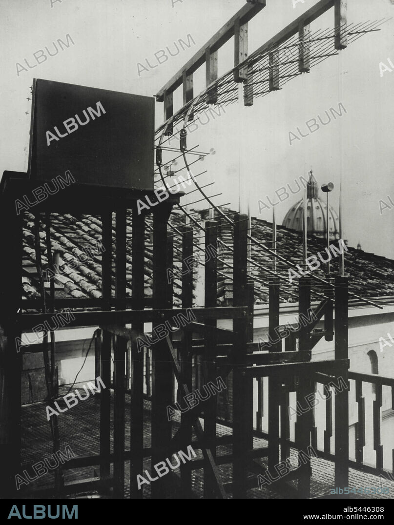 Marconi's New Ultra Short Wave Radio -- A side view of Marcon's first ultra short wave wireless telephone station installed on the roof of the Vatican Radio station. A duplicate installation is at Castel Gandolfo, 20 miles S.E., the Pope's summer residence. The installation uses a 57 centimeter wave and the total electrical consumption is about 30 watts, making apparatus and operation infinitely cheaper than other standard radio transmission. In the metal box on the platform are several small parts of the sending and receiving. December 9, 1932. (Photo by Associated Press Photo).