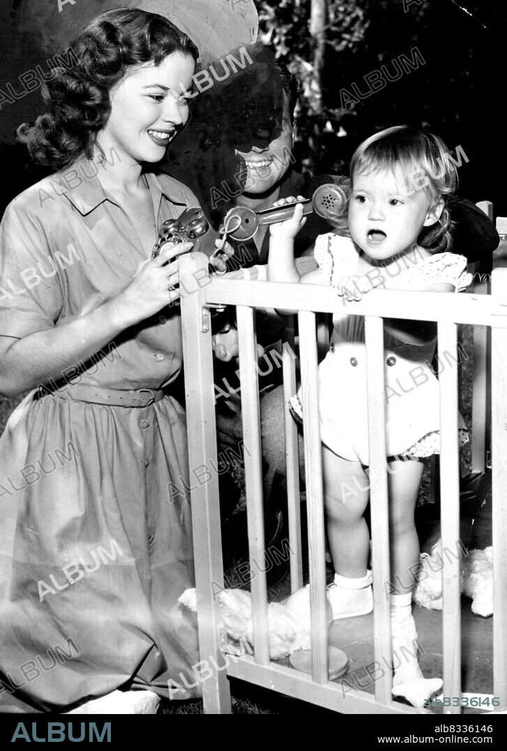 Shirley Temple, 21-year-old actress, and her husband, John Agar, play with their 20--monthsold daughters Linda, in California in Septembers. George Stahlman, Shirley's attorney, announced in Hollywood, Oct. 13, that the one-time child star, and Agar have separated and that he is drawing up divorce papers. November 1, 1949.