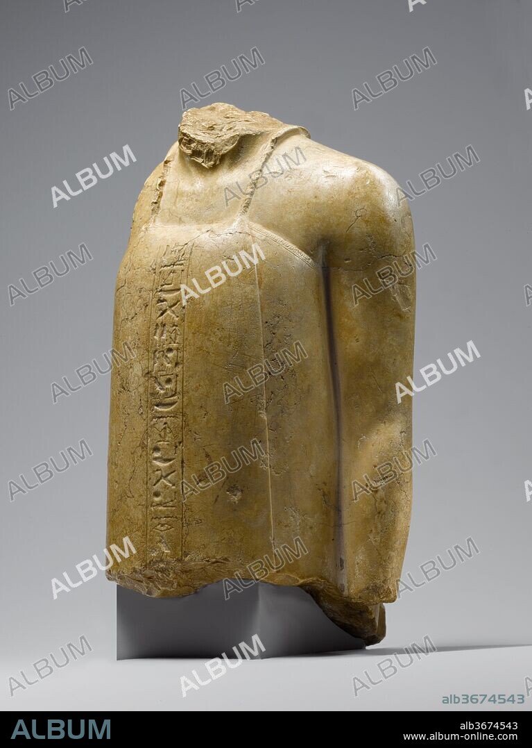 Fragmentary Statuette of a Vizier. Dimensions: H. 10 in. (25.4 cm). Dynasty: Dynasty 18. Reign: reign of Akhenaten. Date: ca. 1353-1336 B.C..
This statue represents a vizier, an official who had administrative and judicial responsibility for half the country.  Around his neck he wears a cord whose ends are held in a sliding cartouche-shaped clasp that can be seen at the back.  The vizier's seal hung from this cord but was typically concealed beneath the upper edge of his wrapped garment.  Columns of inscription refer to the "beautiful light" and the "sole sun of the one who lives seeing him," language that signals the Amarna religion as clearly as the soft modeling of the body, and the natural curve of the arms express the period's aesthetic.