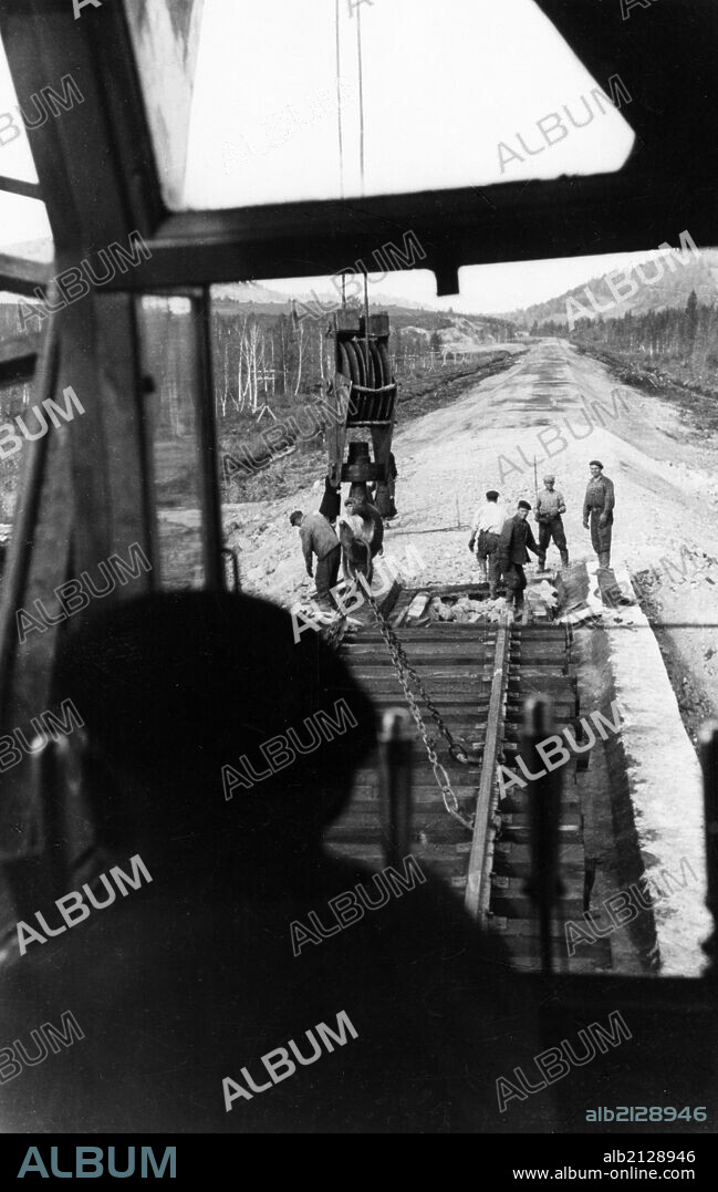 Workers laying track for the 400-mile abakan-taishet railroad through the sayan mountains in siberia, 1960. 01/02/1960