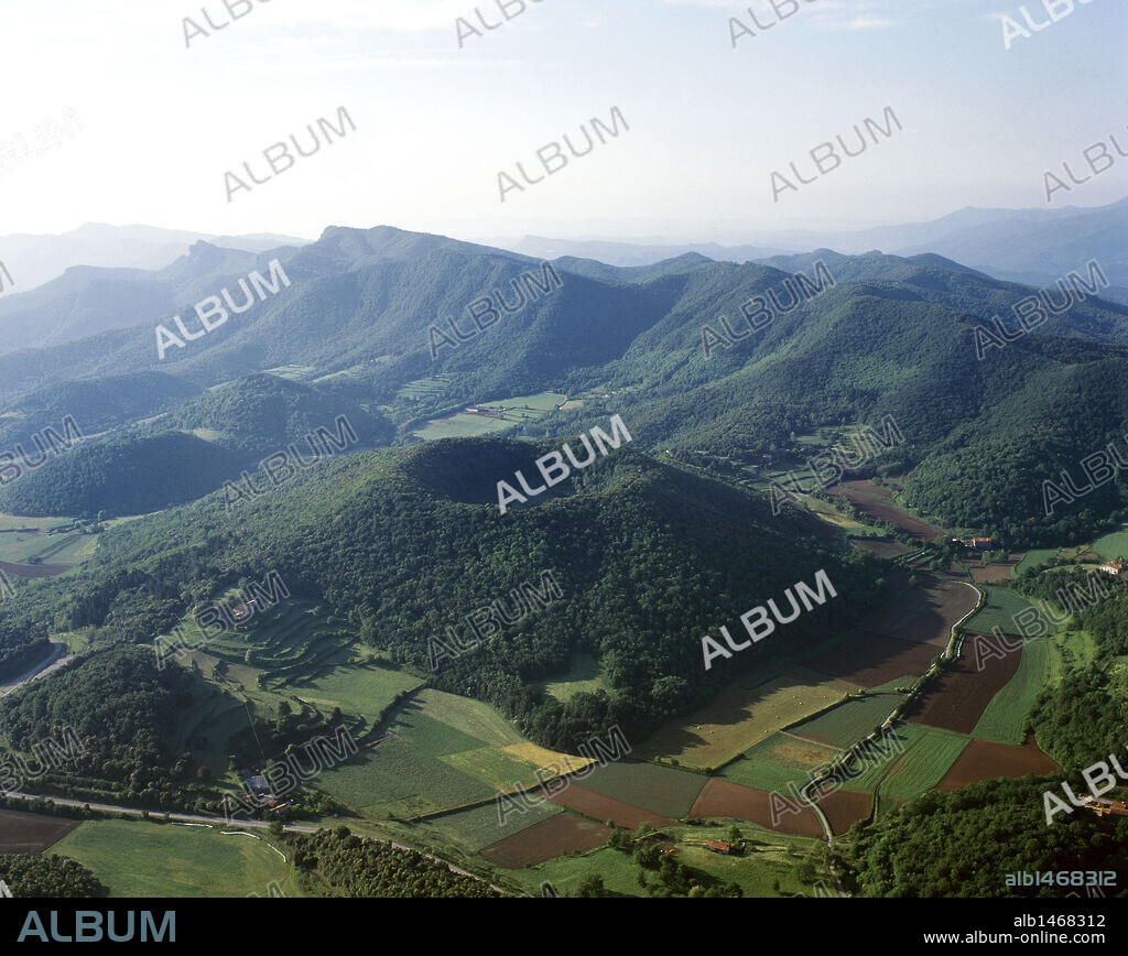Catalonia. La Garrotxa Volcanic Zone Natural Park (Parc Natural de la Zona Volcànica de la Garrotxa). Aerial view of the Catalan Transversal Range with the Santa Margarida volcano. Santa Pau, province of Girona, Garrotxa region. Spain.