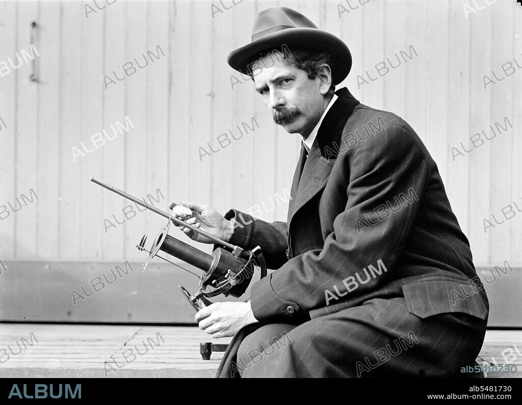 Charles Greeley Abbot, astrophysicist and Secretary of the Smithsonian, with his device: a silver-disc pyrheliometer which measures direct beam solar irradiance ca. 1913-1917.