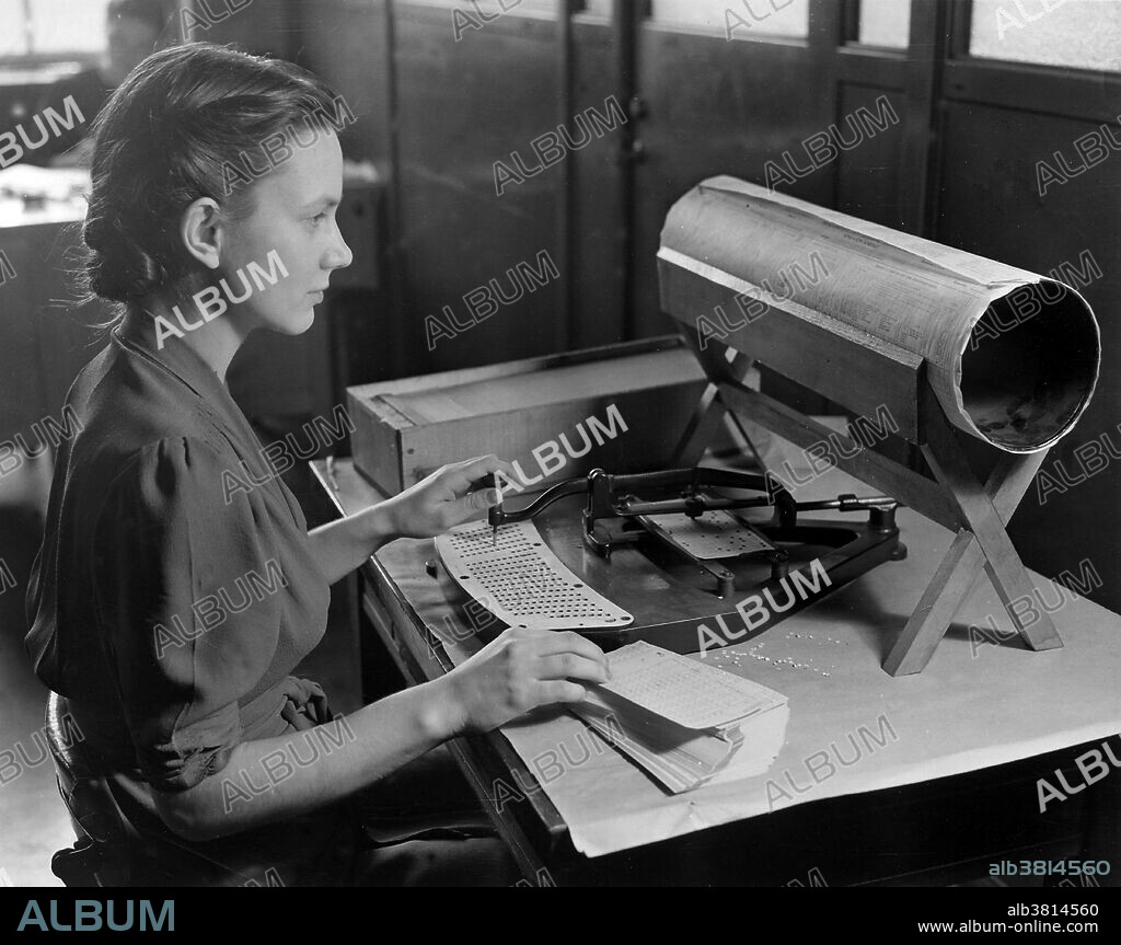 Hollerith Card Puncher, an integral part of the tabulation system used by the United States Census Bureau to compile the thousands of facts gathered by the Bureau. Holes are punched in the card according to a prearranged code transferring the facts from the Census questionnaire into statistics. A punched card reader or just card reader is a computer input device used to read data from punched cards. A card punch is an output device that punches holes in cards under computer control. Sometimes card readers were combined with card punches and, later, other devices to form multifunction machines. Many early computers, such as ENIAC, used punched card input/output. Photograph, circa 1940, appears to be staged as it shows a Hollerith pantograph with a keyboard for the 1920 population card.