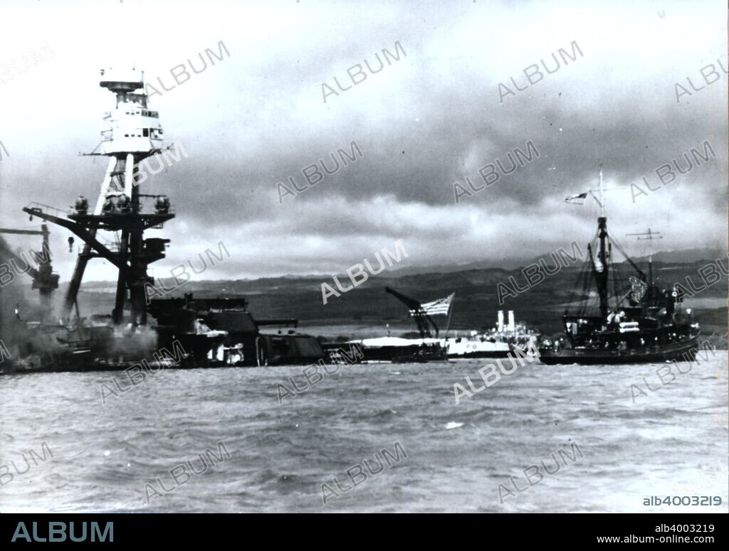 American battleship USS 'Arizona', Pearl Harbour, Hawaii, World War II, 7 December 1941. The 'Arizona' was sunk at its moorings on Battleship Row when Japanese aircraft launched their surprise attack on the US Navy base at Pearl Harbour. The ship was destroyed by a huge explosion in her forward ammunition magazines shortly after a bomb hit and 1177 of the 1400 crewmen on board at the time were killed. The wreck continued to burn for two days after the attack. The ship's superstructure was removed and scrapped in 1942, but the rest of the vessel remains where it sank as a memorial to those killed.