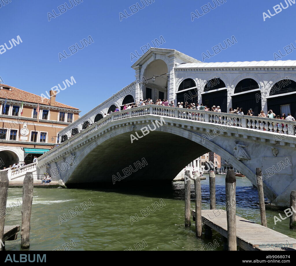 The Rialto Bridge (Ponte di Rialto), spanning the Grand Canal in Venice, Italy. It is the oldest bridge across the canal, and was the dividing line for the districts of San Marco and San Polo. The present stone bridge, a single span designed by Antonio da Ponte, was finally completed in 1591.