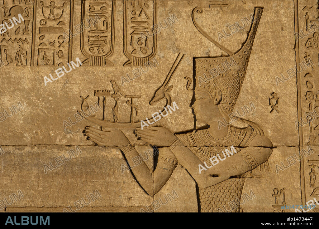 Arte Egipcio. Dendera. Complejo del Templo de Hathor. Mammisi romano o Casa del Nacimiento Divino. El Emperador Trajano, representado como un faraón y con la corona roja, ofrece el barco Henu de Sokar. Relieve. Tercer intercolumnio. Cara Sur.