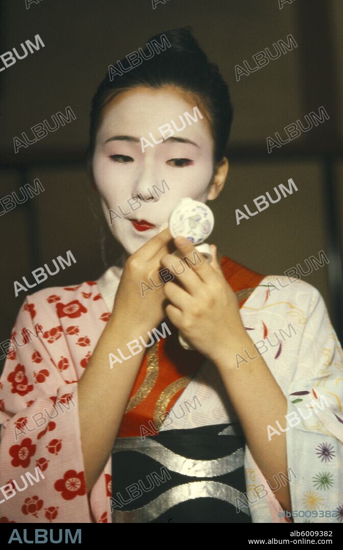 JAPAN General Geisha applying white face powder.