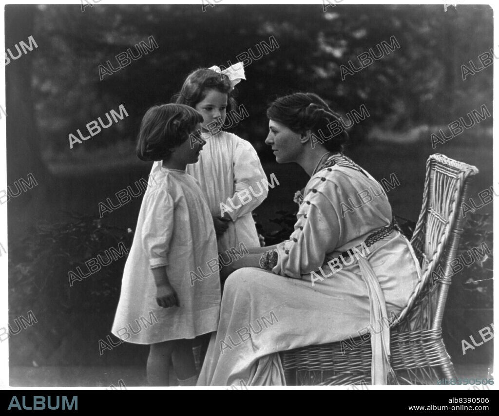 FRANCES BENJAMIN JOHNSTON. Mrs. Frank Vanderlip seated on porch, with two children, not after 1913. [Narcissa Cox Vanderlip was a suffragist, president of the New York Infirmary for Women and Children, co-founder of the New York State League of Women Voters, and mother of six children. She and her husband Frank A. Vanderlip founded the Scarborough School, the first Montessori school in the USA].