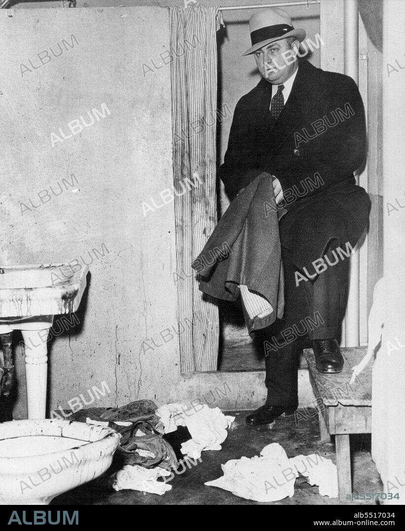 Blood-Spattered walls, fixtures and clothing in bathroom where Richard Loeb, Principal in murder case was fatally slashed by follow convict, James Day, Jan. 28, 1936. Warden Joseph E. Ragen of Stateville Penitentiary views scene. April 23, 1952. (Photo by Associated Press ).