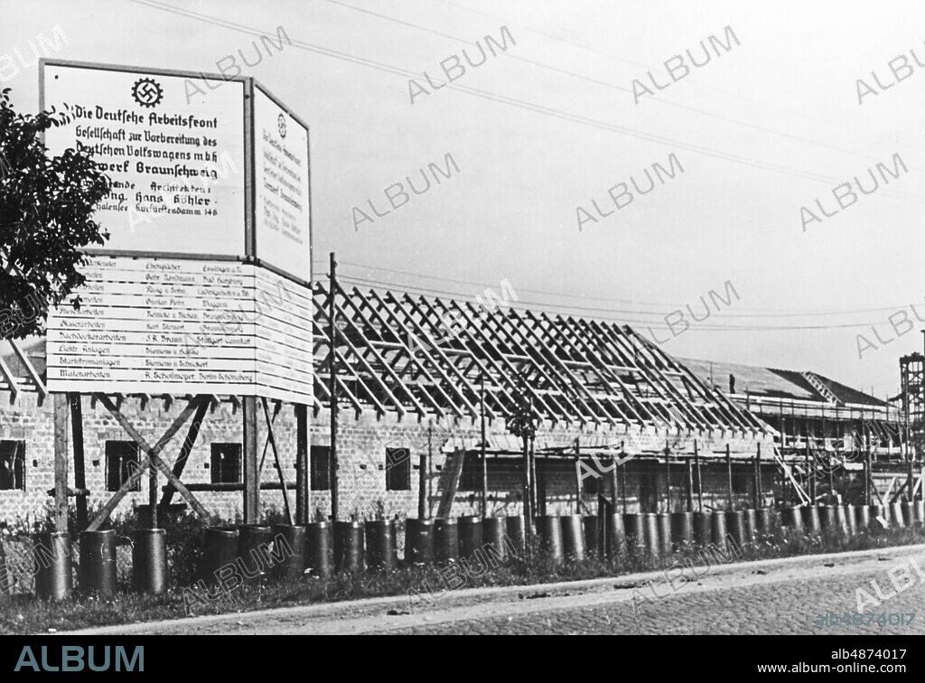 GERMANY 1938-08-10. Orig. bildtext ... DAS GROSSE VORWERK FÜR DEN VOLKSWAGEN ENGSTE. In the immediate vicinity of the city of Braunschweig, on the Fernverkehrsstrasse Hamburg - Braunschweig, the preliminary work for the German Volkswagen is nearing completion. The elongated buildings, which occupy a huge building site, have already been erected up to the roof chair, so that the training of the many thousands of special workers in this prefabrication can soon begin. Photo: Keystone View Company / AB Text & Bilder / SVT / Code: 5600 Folder: KDF-Volkswagen -1939 91B The Volkswagen factory was built on the north side of the Mittelland Canal, on the other side of the canal the city Stadt des KDF-Wagens (from 1945 Wolfsburg) was founded for to make room for the workers at the factory. The Deutsche Arbeitsfront Fabriker sites: GERMANY.