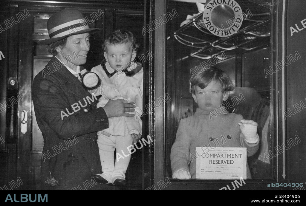 Duke And Duchess Of Kent's Children Leave For Sandringham - Prince Edward looks through the carriage window as the nurses poses in the carriage doorway with little Princess Alexandria.Princess Alexandria, who will be one year old on Christmas Day, and her brother, Prince Edward, left Belgrave Square this afternoon for Sandringham. The Duke and Duchess of Kent will go tomorrow. December 23, 1937. (Photo by Keystone).