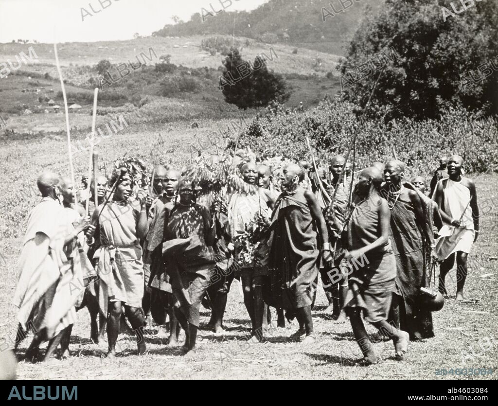 Kenya, Kikuyu women perform a ceremonial dance during an annual circumcision ritual, marking the initiation of adolescent girls into adulthood. Original manuscript caption: Dance before the circumcision of girls at puberty, by an old woman with a rusty knife (Cliterodectomy). South Nyeri, 1936, 1937. 1995/076/1/2/5/26.