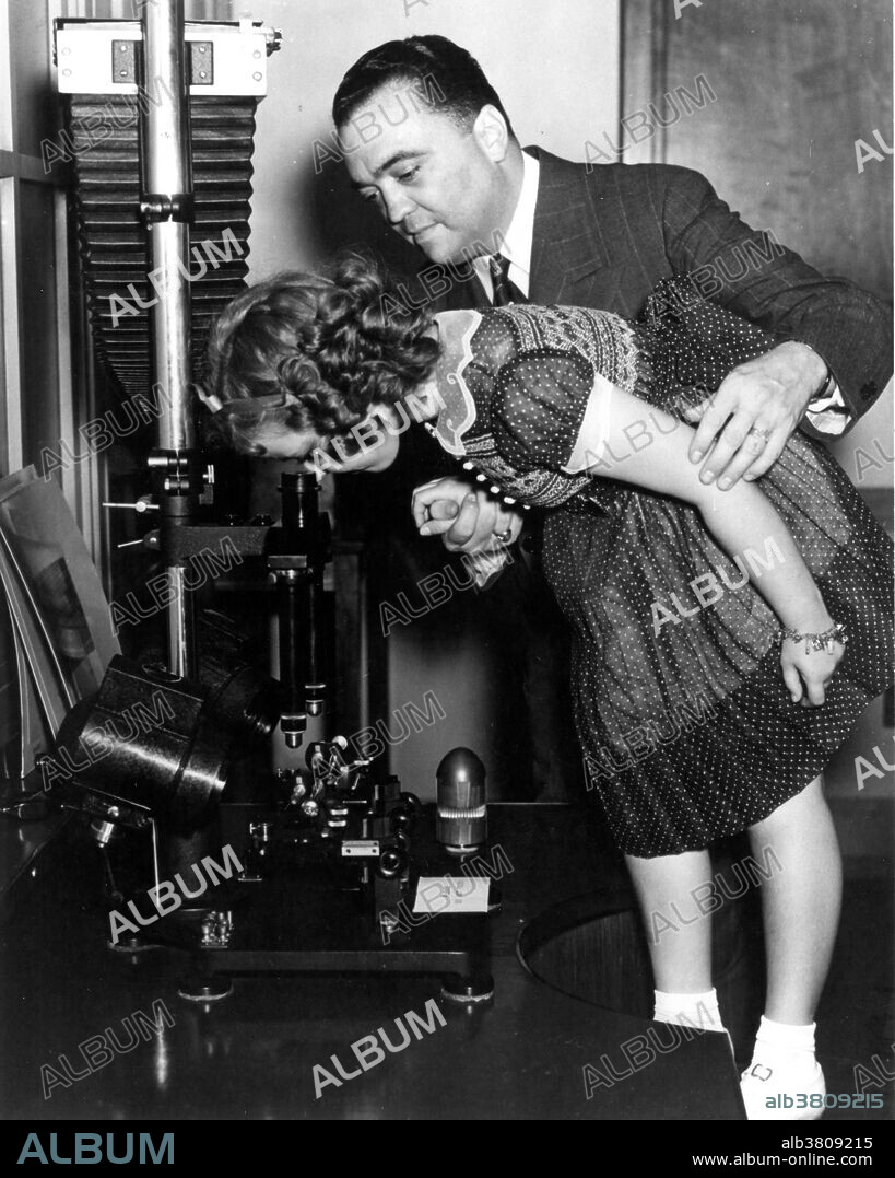 Director Hoover helps movie star Shirley Temple during her tour of FBI Headquarters on June 28, 1938. John Edgar Hoover (January 1, 1895 - May 2, 1972) was the first Director of the Federal Bureau of Investigation (FBI) of the United States. Appointed director of the Bureau of Investigation - predecessor to the FBI - in 1924, he was instrumental in founding the FBI in 1935, where he remained director until his death. Shirley Temple Black (April 23, 1928 - February 10, 2014) was an American actress, singer, dancer, businesswoman and diplomat most notable as Hollywood's number one box-office star from 1935-38. She retired from films in 1950 at the age of 22. As an adult, she was named United States ambassador to Ghana and to Czechoslovakia and also served as Chief of Protocol of the United States.