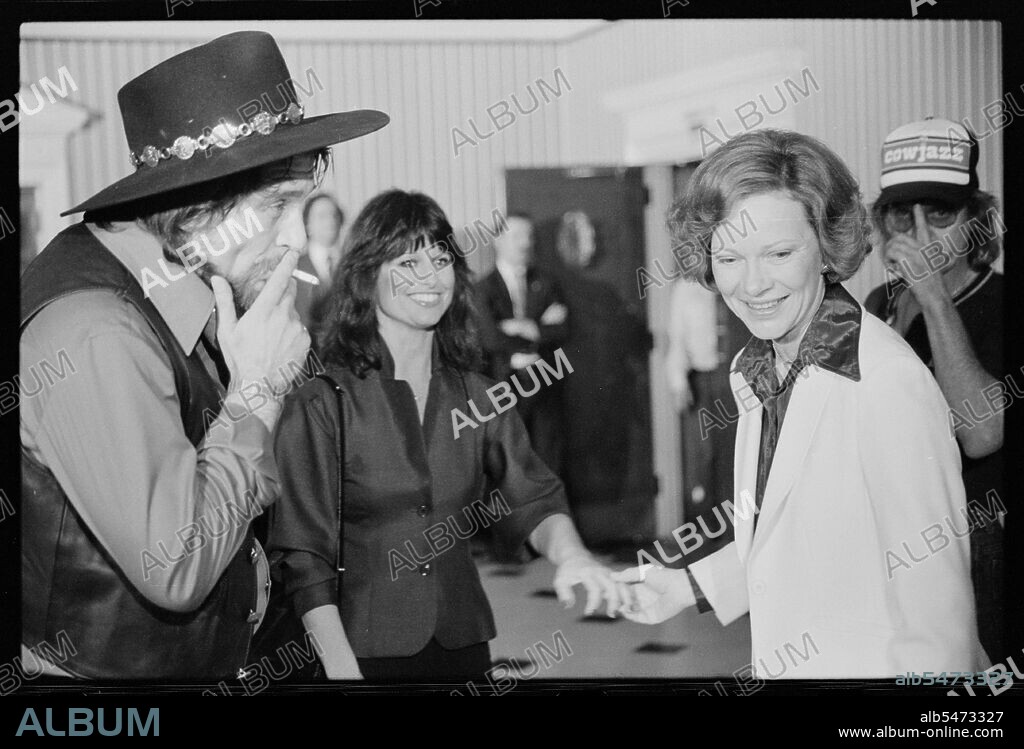 April 23, 1980 - First Lady Rosalynn Carter with Waylon Jennings, smoking a cigarette, and Jesse Colter at a reception preceding a concert to benefit the Carter-Mondale campaign.