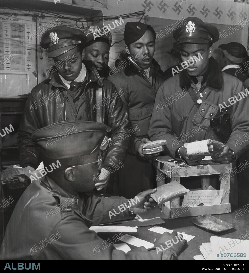 Cyanide "Escape Kits" Being Distributed to Fighter Pilots at Air Base, Seated: Theodore G. Lumpkin, Jr., Standing (left to right): Joseph L. "Joe" Chineworth, Memphis, TN, Class 44-E; Robert C. Robinson, Asheville, NC, Class 44-G; Driskell B. Ponder, Chicago, IL, Class 43-I; Robert W. Williams, Ottumwa, IA, Class 44-E, Ramitelli, Italy, Toni Frissell, March 1945.