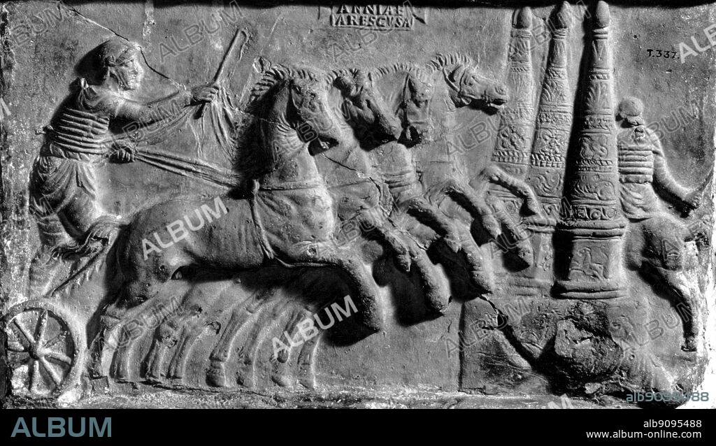 Roman Quadriga. The chariot is racing along the spina in the centre of the circus on one of its seven laps; the driver is about to turn left-handed round the turning-posts. His reins are Y-shaped, the two ends meeting at the withers. The charioteer thus holds a single rein for each horse, whose head he cannot turn. The reins are wrapped round his waist so that he can slow or stop his team by leaning back. The History of Horse Racing by Roger Longrigg, page 14.