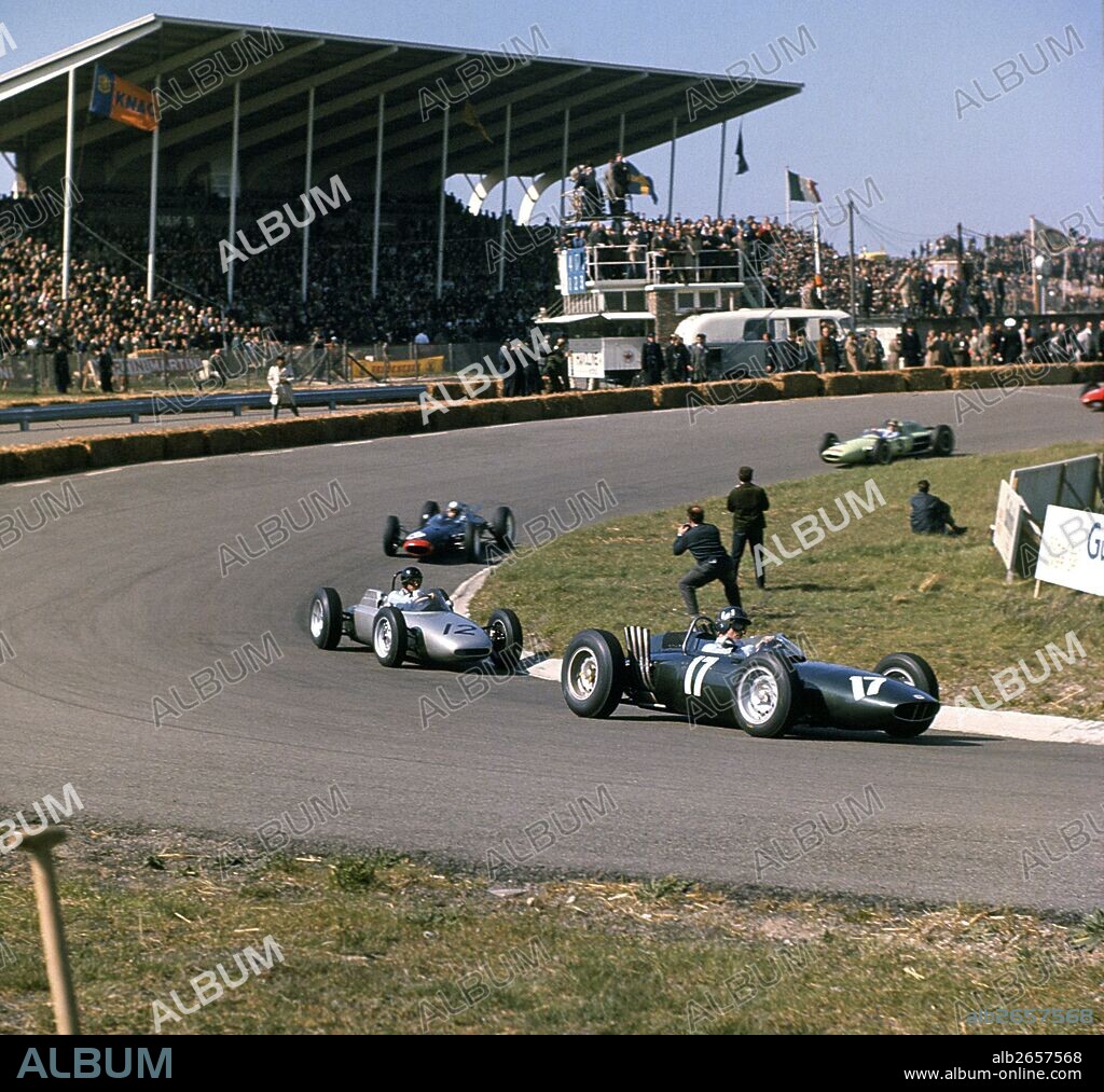 Graham Hill leads Dan Gurney Porsche flat-8 and John Surtees Lola-Climax V8 in the Hunzerug corner, Dutch GP, Zandvoort. Hill won race. 20th May 1962.